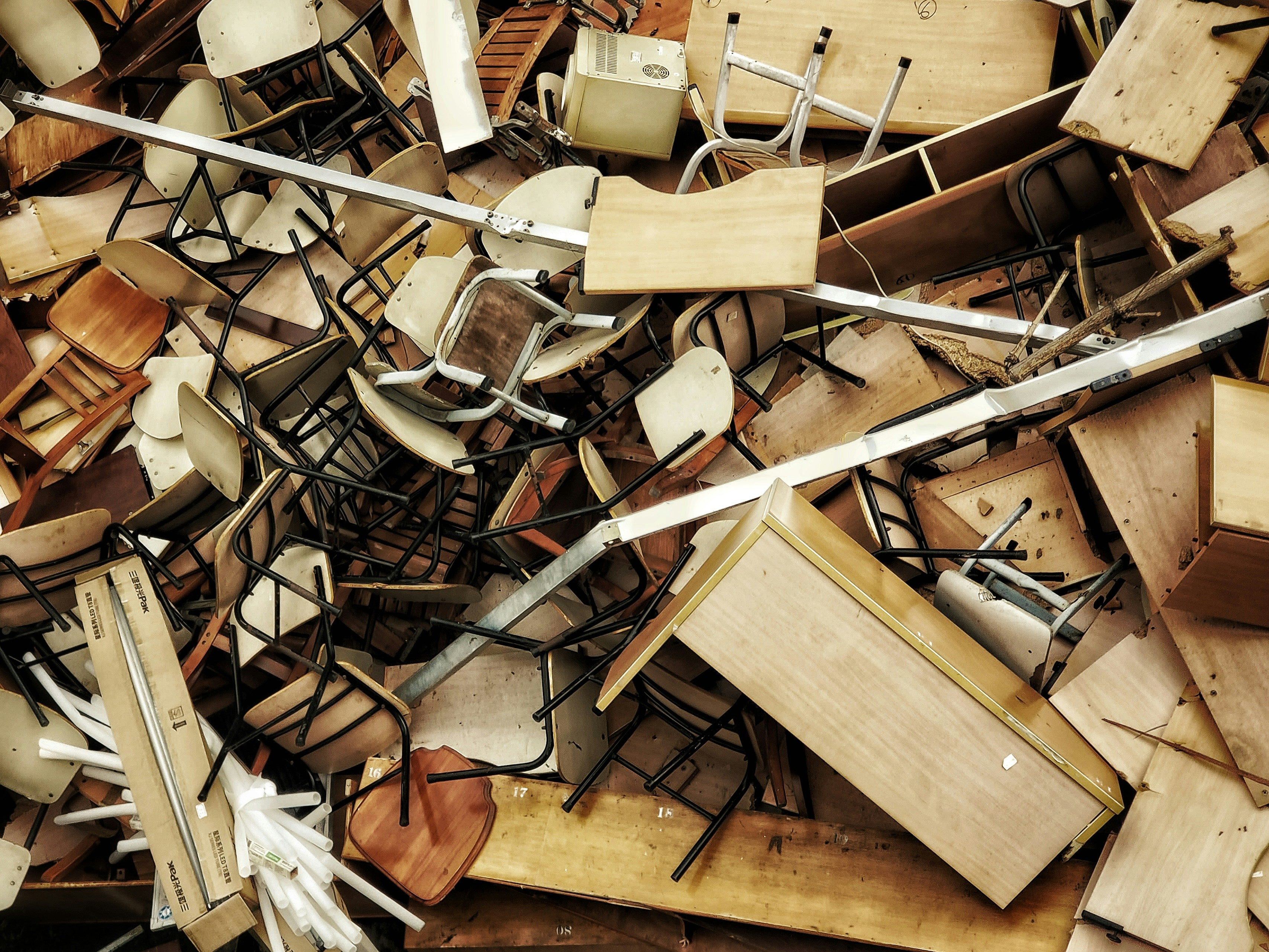 Pile of discarded school chairs and desks.